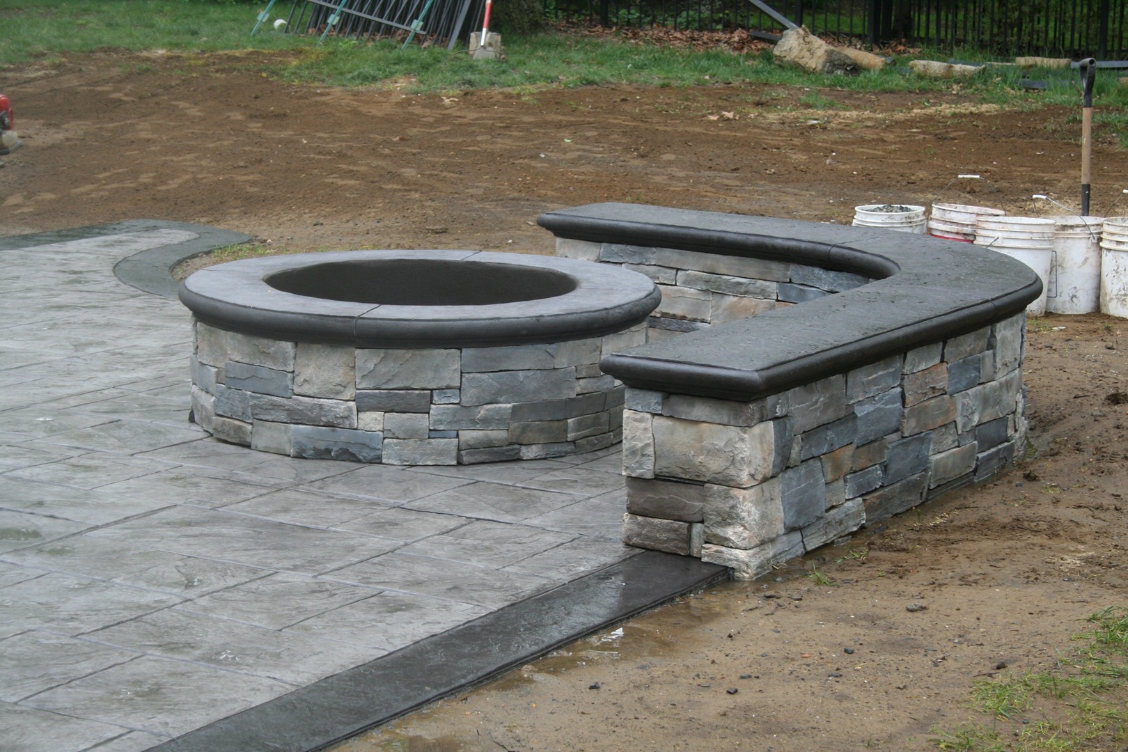 Stamped Concrete Patio with Stone Fire Pit and Retaining Wall
