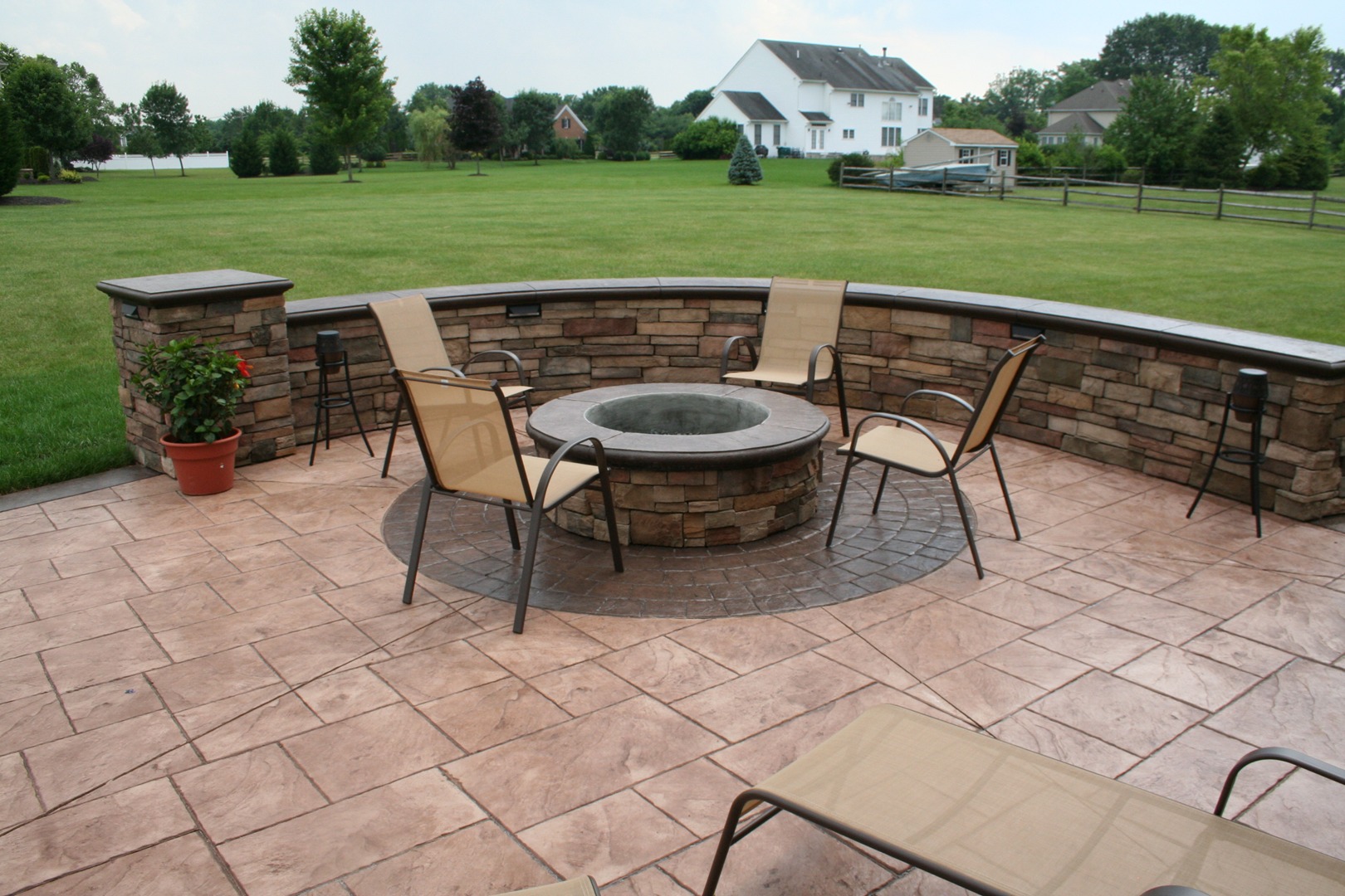 Stamped Concrete Patio with Stone Fire Pit and Retaining Wall